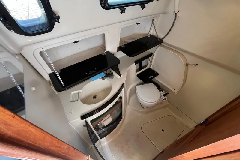 Slide: The Image of Interior of a 1994 Hunter 29.5 sailboat bathroom with sink and toilet. - 38
