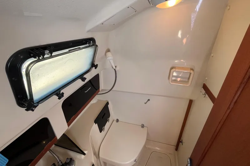 Slide: The Image of 1994 Hunter 29.5 boat bathroom with window, shower, and compact design. - 39