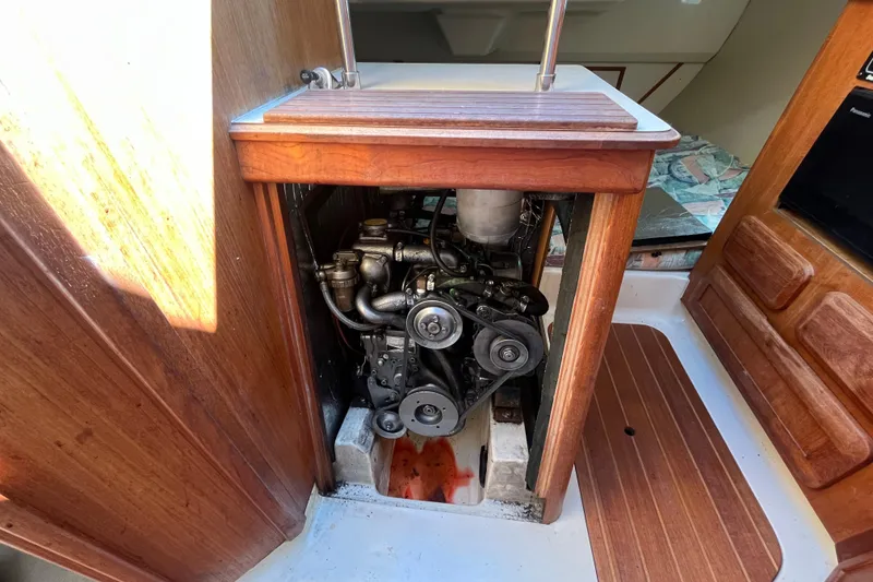 Slide: The Image of Engine compartment of a 1994 Hunter 29.5 sailboat, showcasing mechanical components. - 40