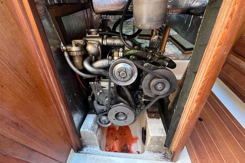 Slide: The Image of Engine compartment of a 1994 Hunter 29.5 sailboat, showcasing mechanical components. - 41