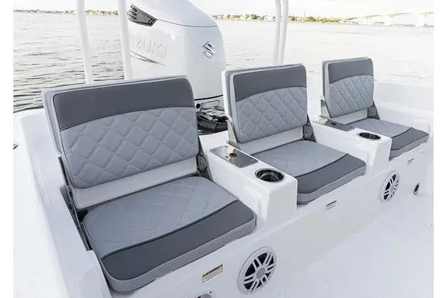 Slide: The Image of Manufacturer Provided Image: 2024 NauticStar 231 Hybrid boat seats with gray cushions and cup holders. - 12