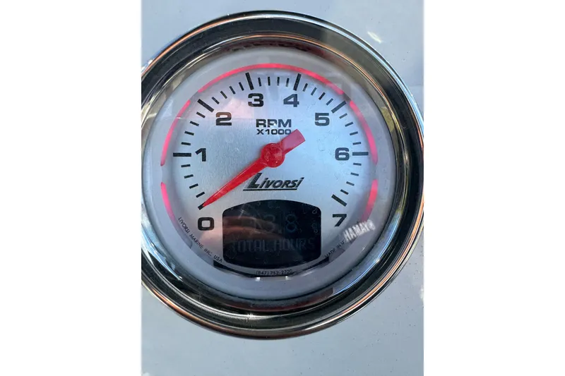 Slide: The Image of Tachometer gauge on 2024 NauticStar 231 Hybrid boat, displaying RPM and total hours. - 7