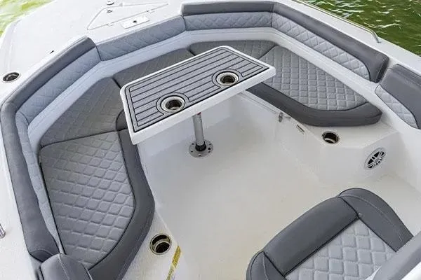 Slide: The Image of Manufacturer Provided Image: 2024 NauticStar 231 Hybrid boat interior with cushioned seating and table. - 9