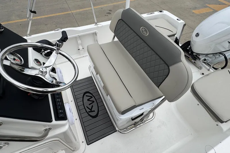 Slide: The Image of 2026 Key West 1720 Center Console boat interior with steering wheel and cushioned seating. - 11
