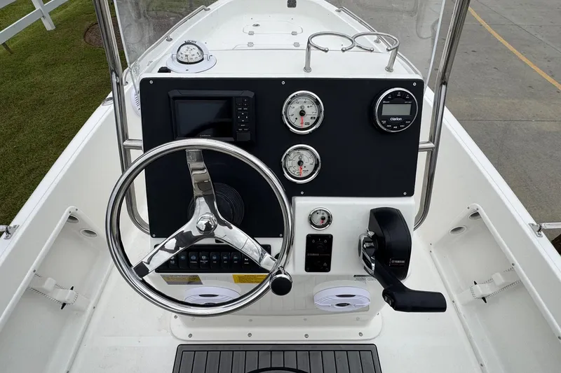 Slide: The Image of 2026 Key West 1720 Center Console boat dashboard with steering wheel and gauges. - 13