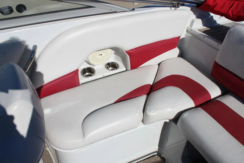 Slide: The Image of 2019 Crownline 205 SS boat interior with red and white seating and cup holders. - 11