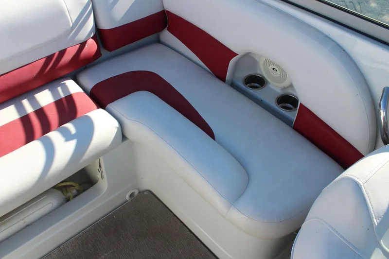 Slide: The Image of 2019 Crownline 205 SS boat interior with red and white seating and cup holders. - 12