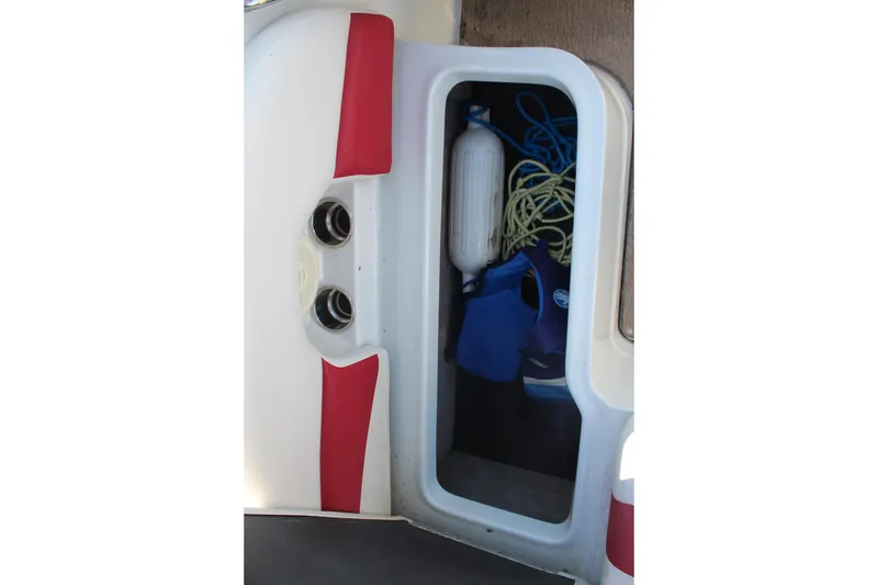 Slide: The Image of Storage compartment in a 2019 Crownline 205 SS boat with life jacket and rope. - 14
