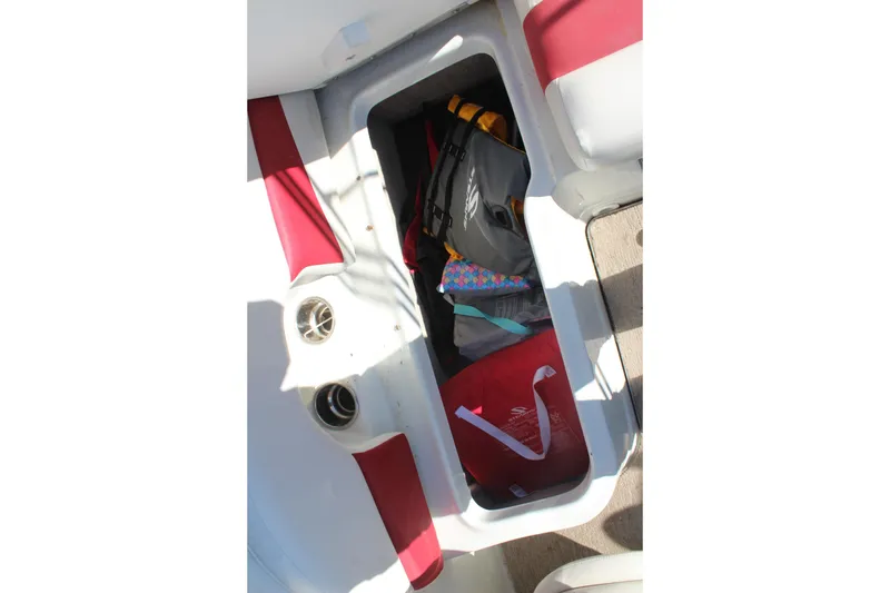Slide: The Image of Storage compartment in 2019 Crownline 205 SS boat with bags and gear. - 15