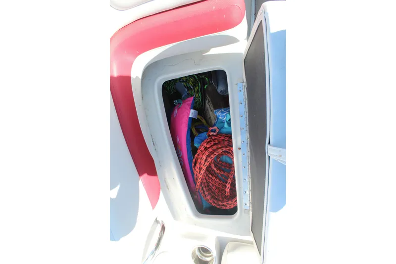 Slide: The Image of Storage compartment of a 2019 Crownline 205 SS boat with ropes and gear. - 24