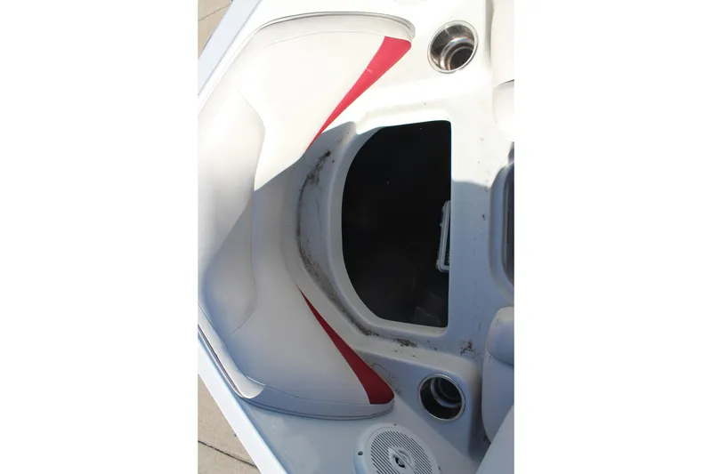 Slide: The Image of 2019 Crownline 205 SS boat interior with red accents and storage compartment. - 25