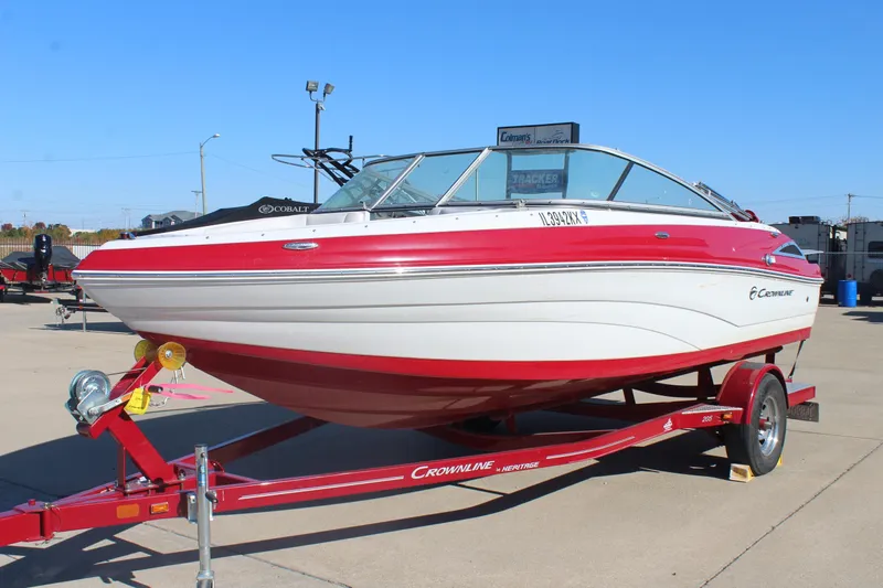 Slide: The Image of 2019 Crownline 205 SS boat on trailer, red and white design, parked outdoors. - 3