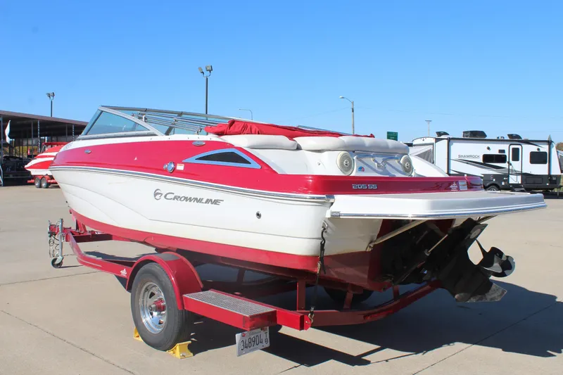 Slide: The Image of 2019 Crownline 205 SS boat on trailer, red and white design, parked outdoors. - 5