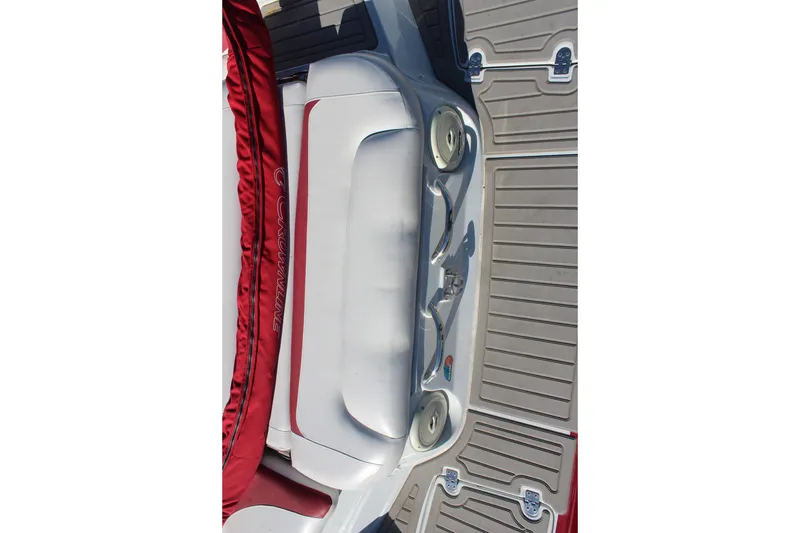 Slide: The Image of 2019 Crownline 205 SS boat interior with red and white seating and gray flooring. - 9