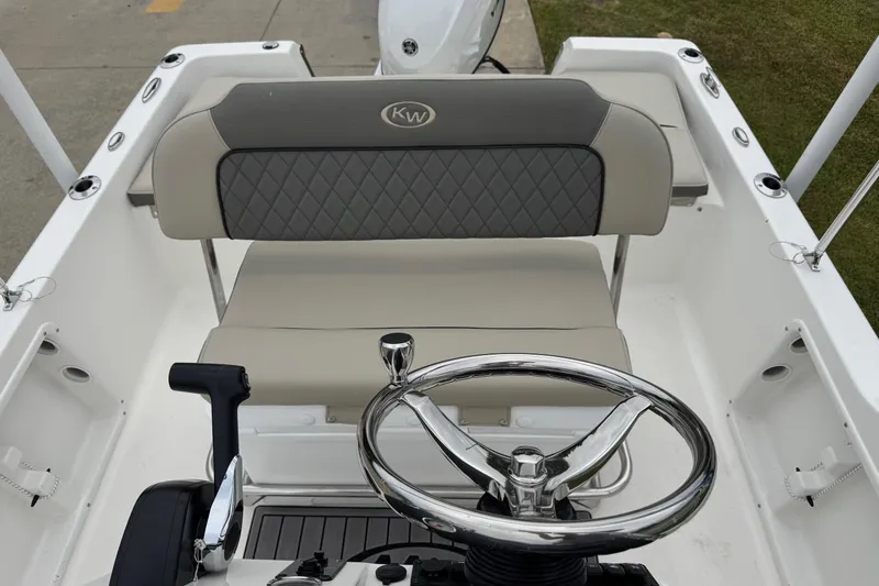 Slide: The Image of 2026 Key West 1720 Center Console boat interior with steering wheel and cushioned seating. - 10