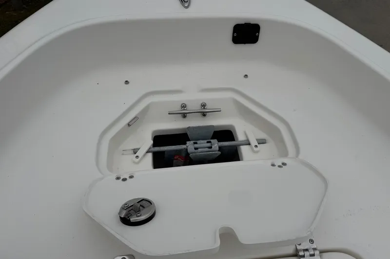 Slide: The Image of 2026 Key West 1720 Center Console boat anchor storage compartment, open lid, white interior. - 6