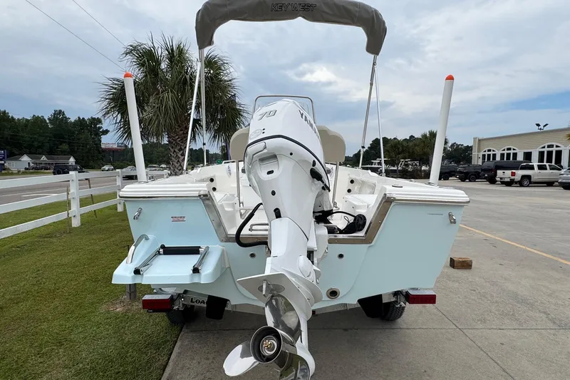 Slide: The Image of 2026 Key West 1720 Center Console boat with Yamaha outboard motor, parked on concrete. - 4