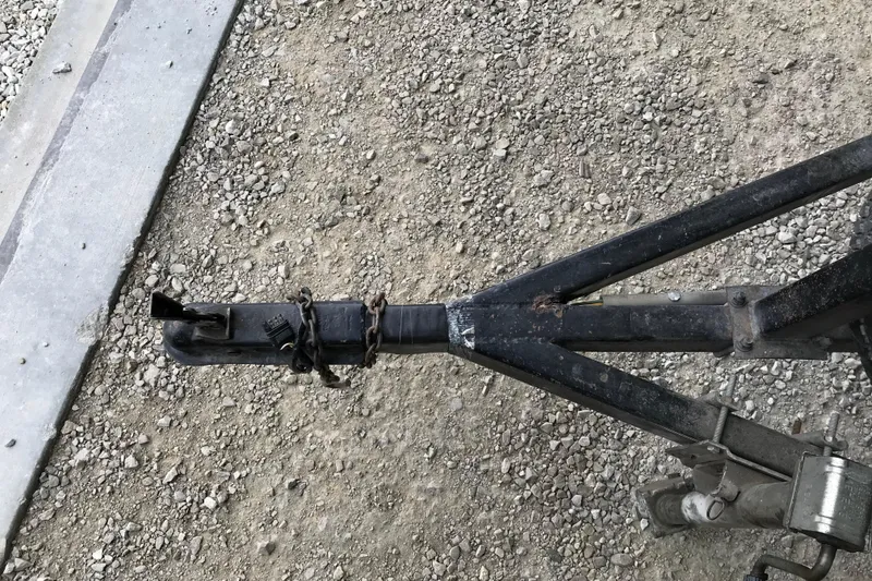 Slide: The Image of Trailer hitch of a 1995 Alumacraft Lunker 165 LTD on gravel surface. - 12