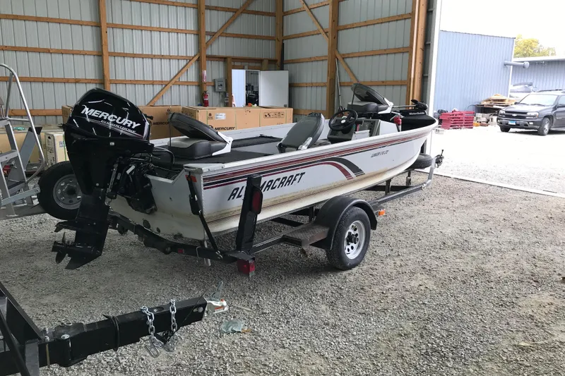 Slide: The Image of 1995 Alumacraft Lunker 165 LTD boat with Mercury engine on trailer in storage shed. - 4