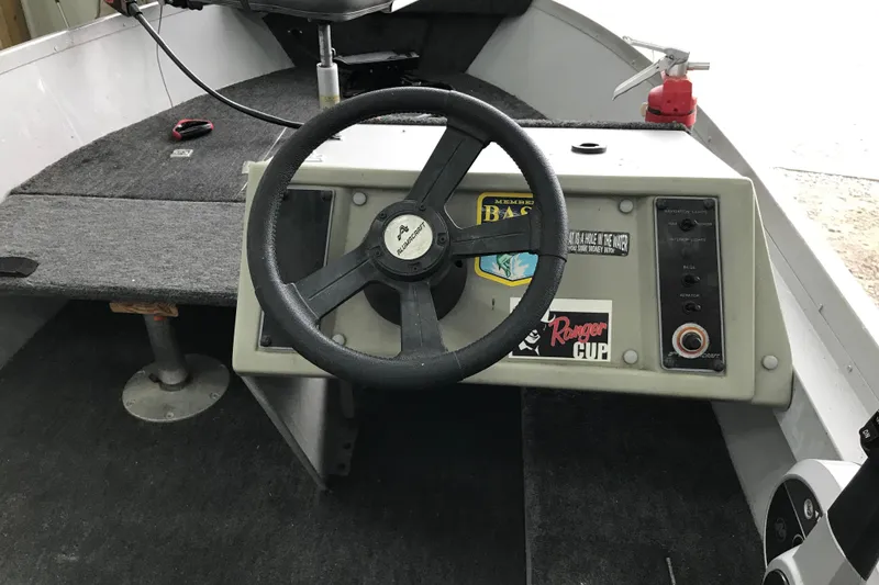 Slide: The Image of 1995 Alumacraft Lunker 165 LTD boat dashboard with steering wheel and control panel. - 5