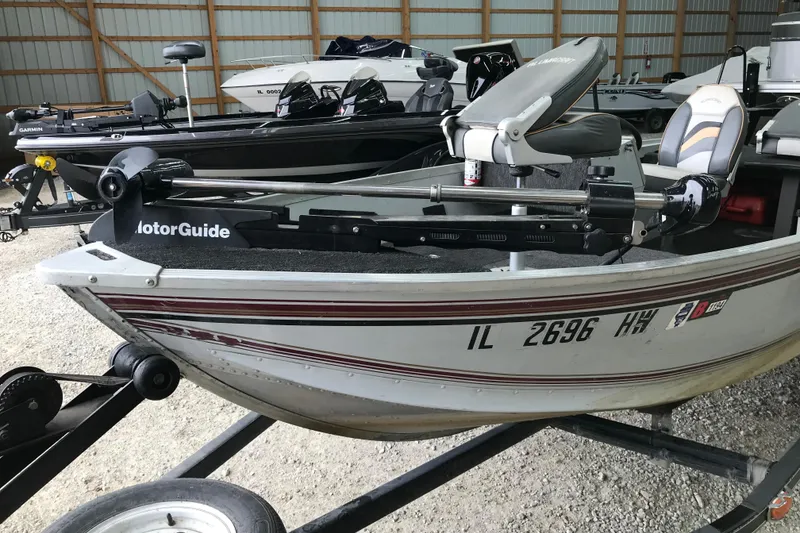 Slide: The Image of 1995 Alumacraft Lunker 165 LTD boat with MotorGuide trolling motor in a storage facility. - 7