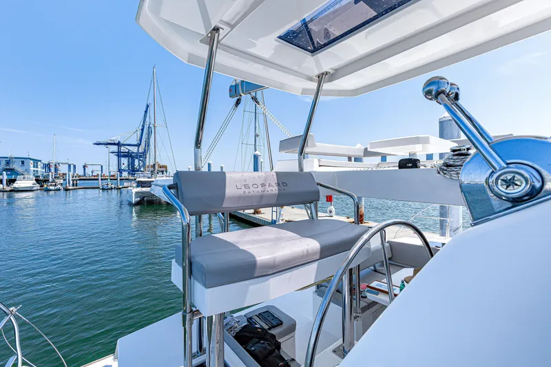 Slide: The Image of 2023 Leopard 42 catamaran helm station with marina view, featuring modern design and controls. - 10