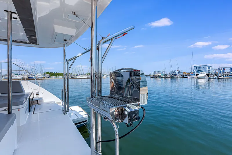 Slide: The Image of 2023 Leopard 42 yacht with grill, docked at marina under clear blue sky. - 12