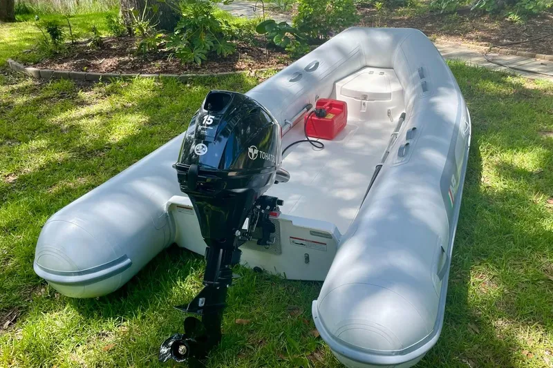 Slide: The Image of 2023 Leopard 42 inflatable boat with Tohatsu motor on grassy area. - 29