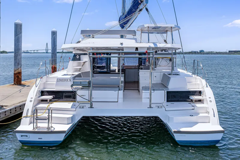 Slide: The Image of 2023 Leopard 42 catamaran docked at marina, rear view with open deck and seating. - 3