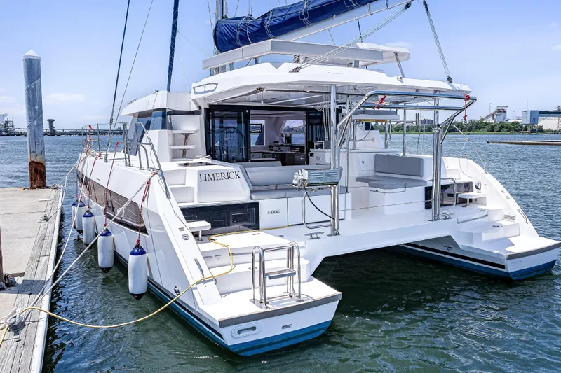 Slide: The Image of 2023 Leopard 42 catamaran docked at marina, featuring spacious deck and modern design. - 4
