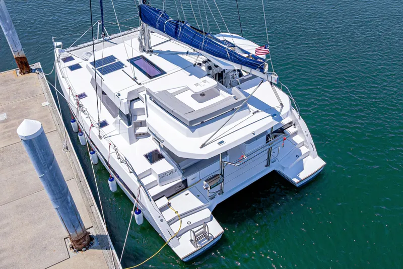 Slide: The Image of 2023 Leopard 42 catamaran docked, featuring solar panels and sleek design. - 5