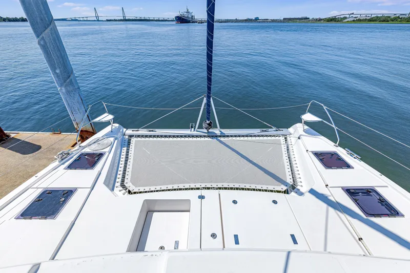 Slide: The Image of 2023 Leopard 42 catamaran on calm water with bridge and ship in background. - 7