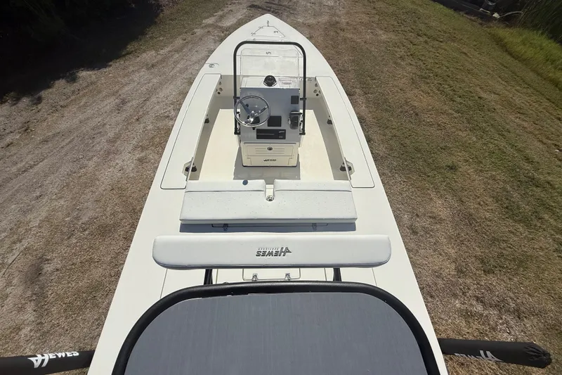 Slide: The Image of 2026 Hewes 18 Redfisher boat on land, top view showing console and seating. - 13