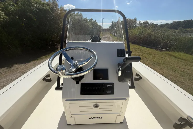 Slide: The Image of 2026 Hewes 18 Redfisher boat console with steering wheel and controls. - 15