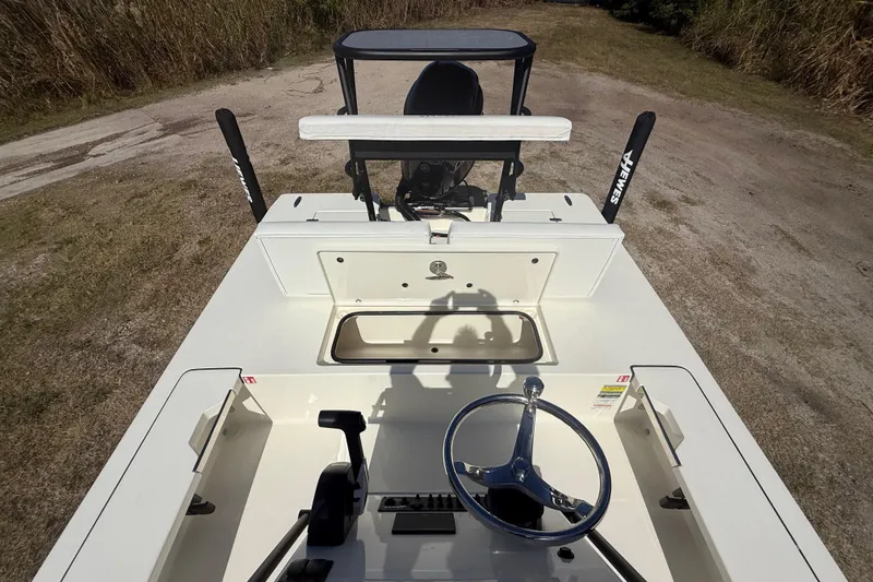 Slide: The Image of 2026 Hewes 18 Redfisher boat interior with steering wheel and control panel. - 22