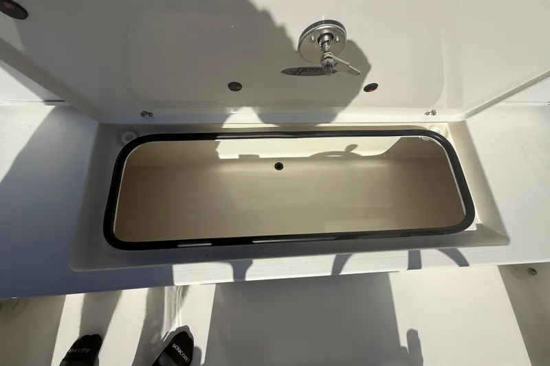 Slide: The Image of Open storage compartment on 2026 Hewes 18 Redfisher boat, showcasing interior space. - 23
