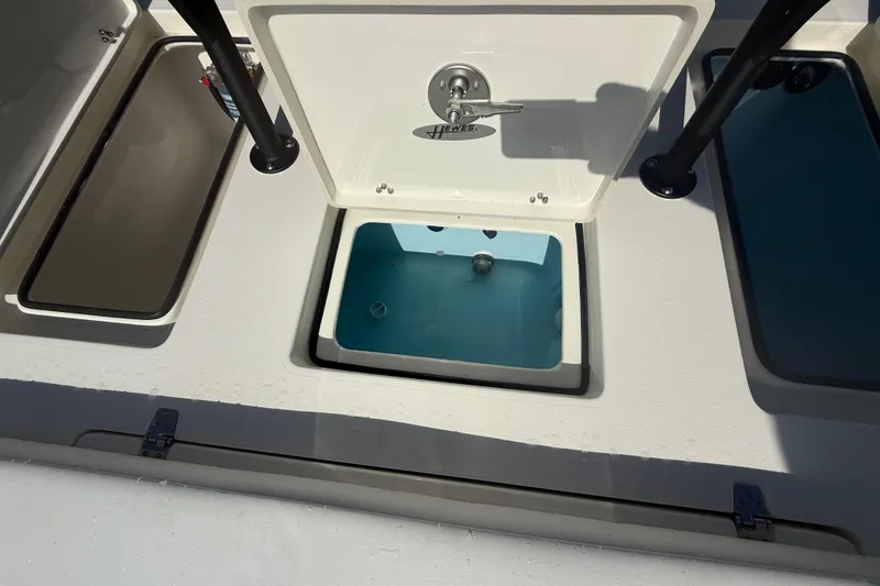 Slide: The Image of 2026 Hewes 18 Redfisher boat livewell and storage compartments. - 26