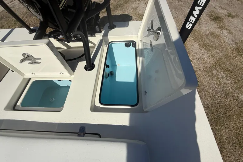 Slide: The Image of 2026 Hewes 18 Redfisher boat with open storage compartments and clean interior. - 27