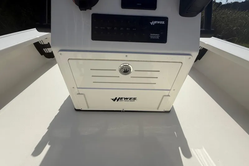 Slide: The Image of 2026 Hewes 18 Redfisher boat console with storage compartment and control panel. - 28