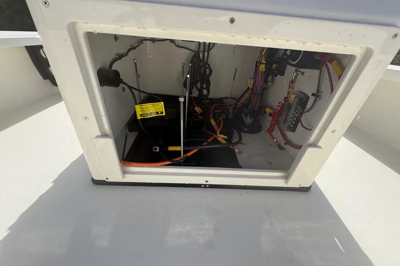 Slide: The Image of Electrical compartment of 2026 Hewes 18 Redfisher boat, showcasing wiring and components. - 29