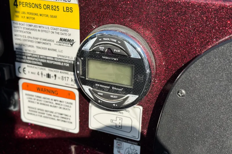 Slide: The Image of Control panel of a 2019 Nitro Z21 boat with safety labels and audio system. - 24