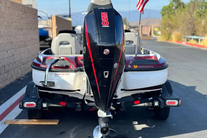Slide: The Image of 2019 Nitro Z21 boat with outboard motor and American flag on trailer. - 4