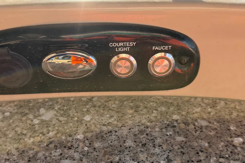 Slide: The Image of Control panel of 2015 Regency 250 LE with courtesy light and faucet buttons. - 10