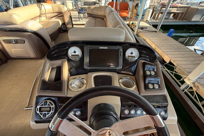 Slide: The Image of 2015 Regency 250 LE boat dashboard with steering wheel and navigation controls. - 11
