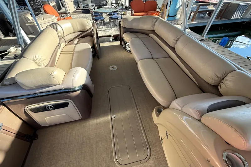 Slide: The Image of Luxurious seating on 2015 Regency 250 LE pontoon boat, docked with outdoor furniture. - 6