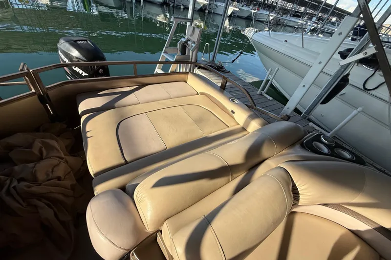 Slide: The Image of Luxurious 2015 Regency 250 LE boat interior with beige seating at marina. - 9