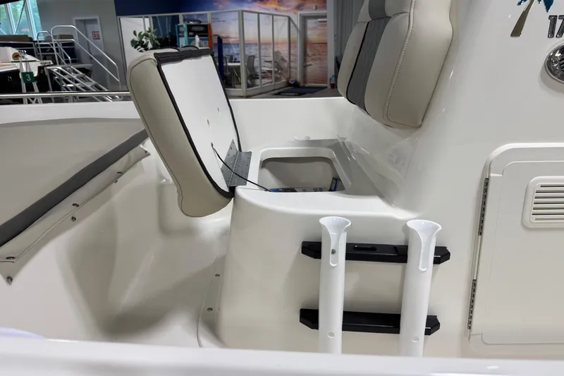 Slide: The Image of 2026 Key West 1720 Center Console boat interior with open storage compartment and seating. - 11