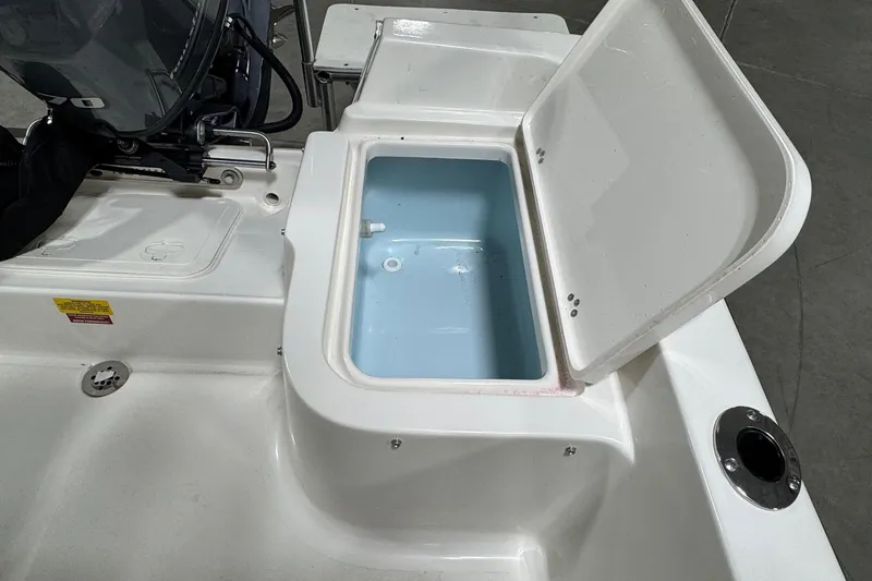 Slide: The Image of Open storage compartment on 2026 Key West 1720 Center Console boat. - 18