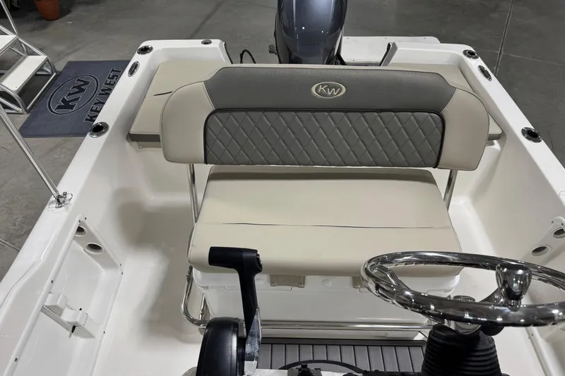 Slide: The Image of 2026 Key West 1720 Center Console boat interior with steering wheel and cushioned seating. - 13
