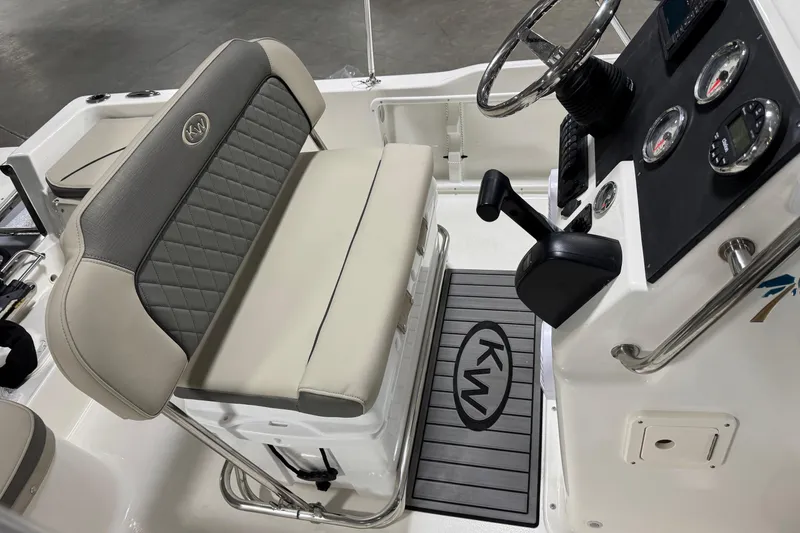 Slide: The Image of 2026 Key West 1720 Center Console interior with steering wheel, gauges, and cushioned seating. - 14